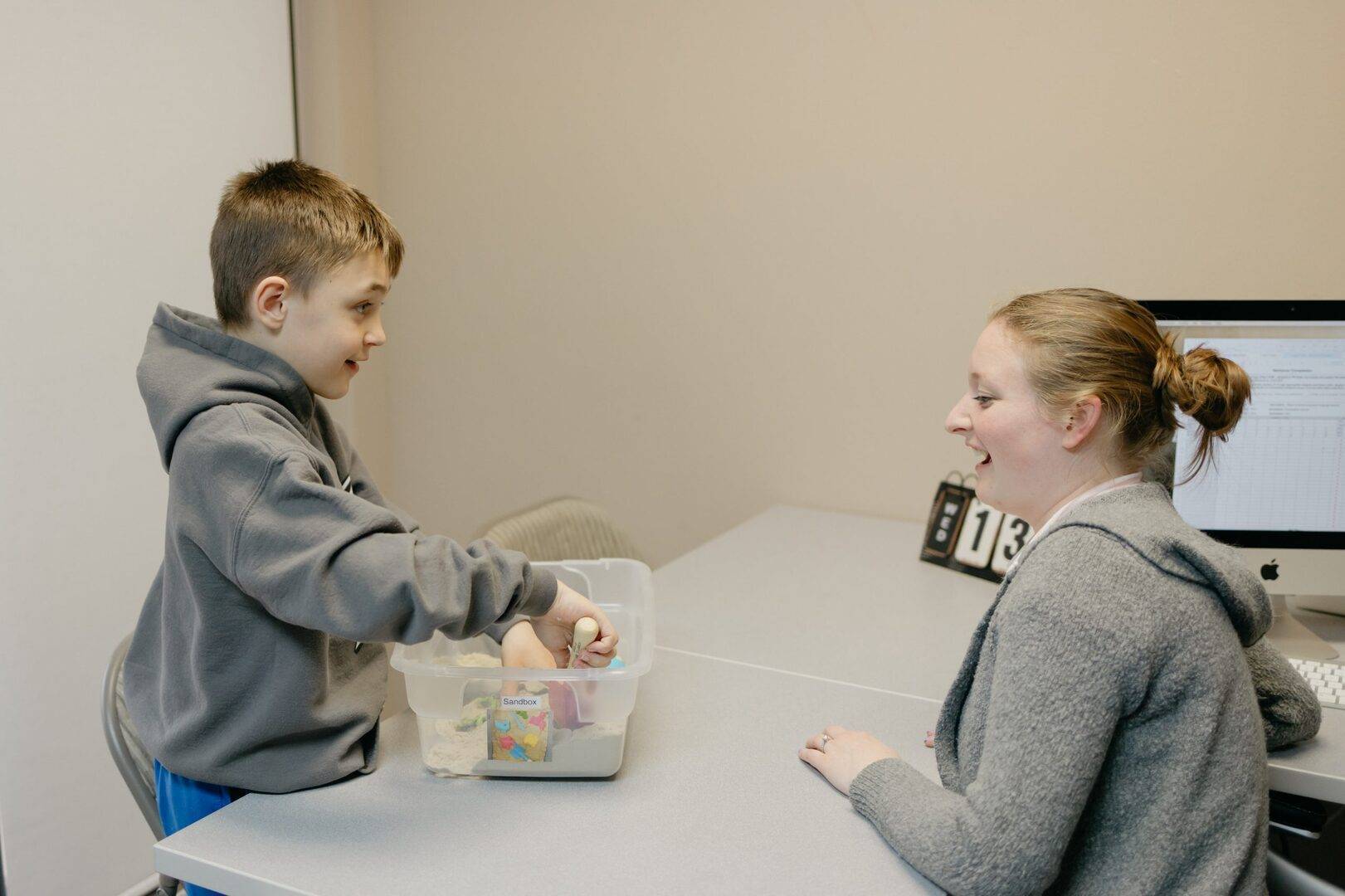 speech pathologist assisting student in reading