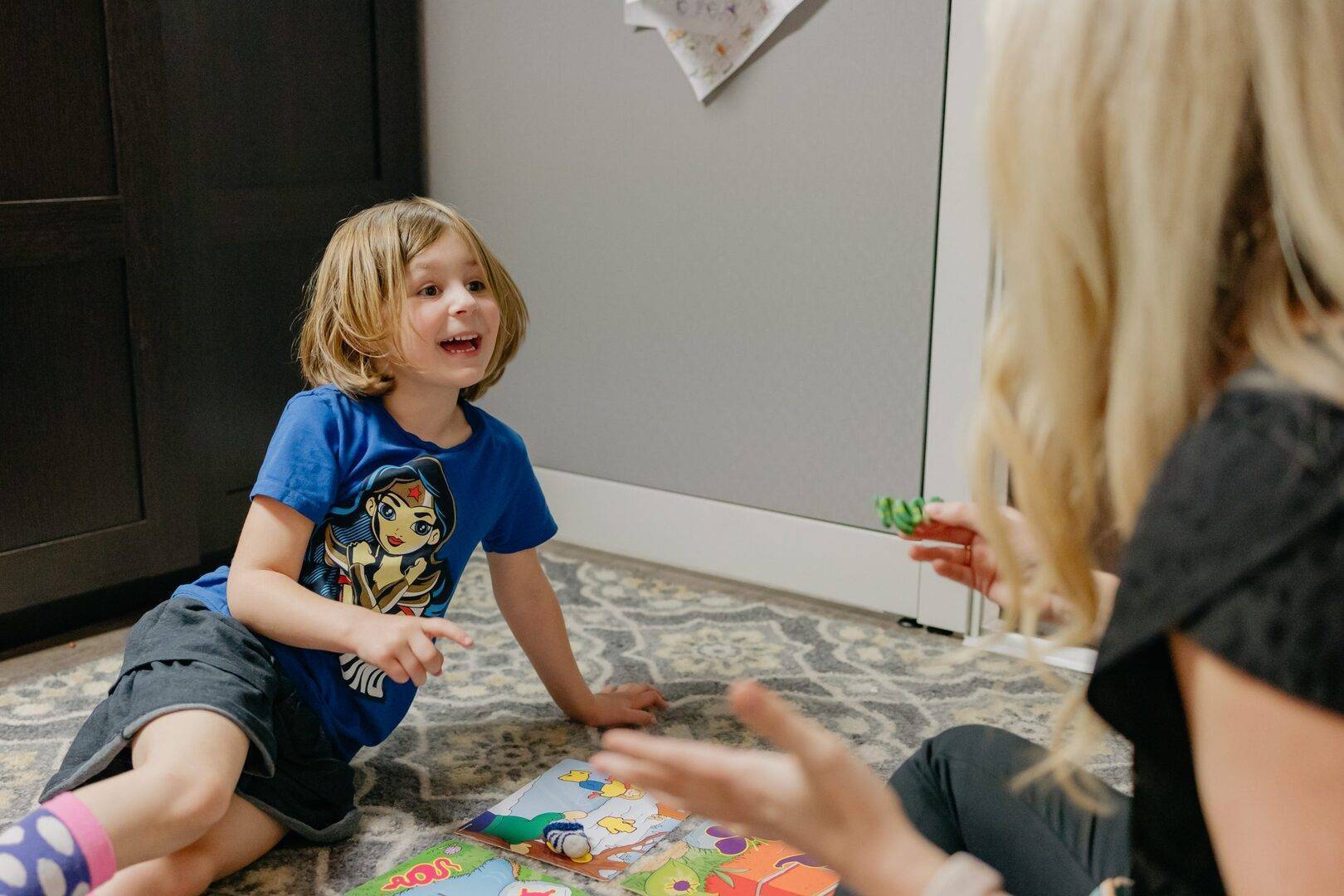 Child sitting on the floor playing with toys and books