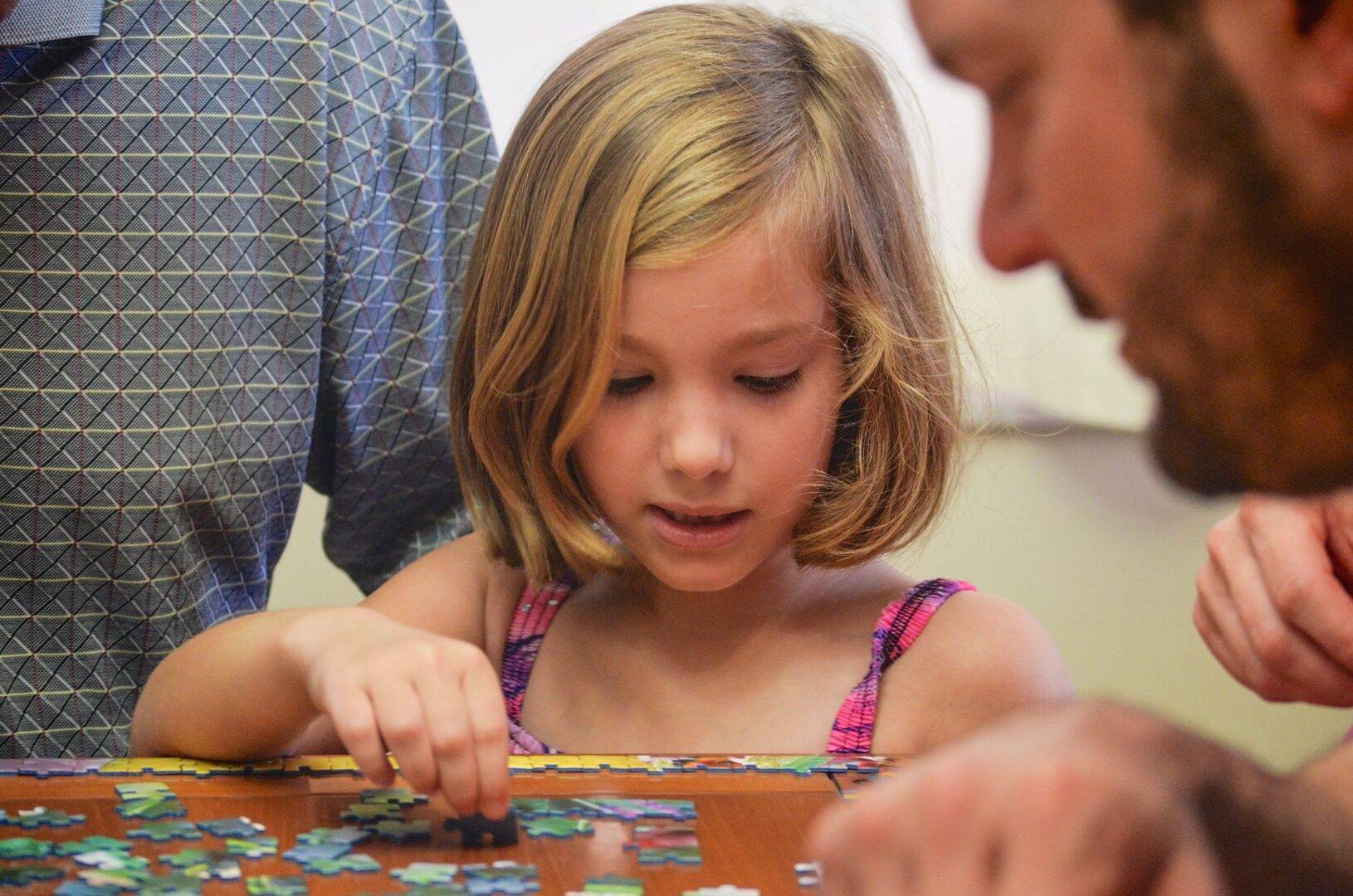 Little girl doing a puzzle