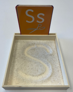 letter "s" written in sand