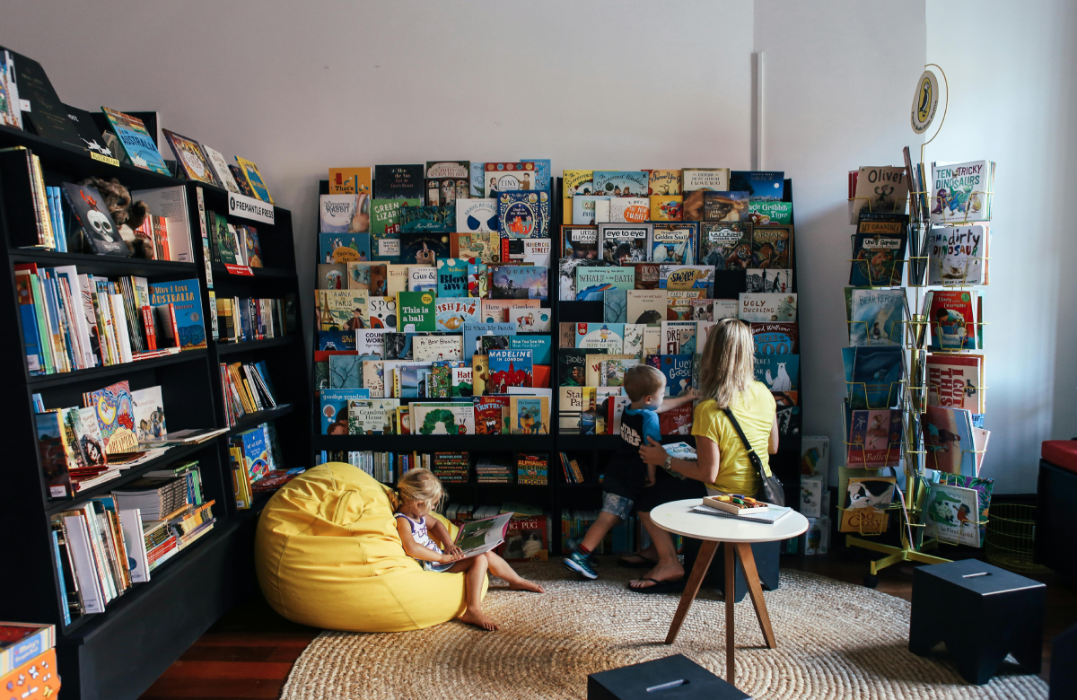woman in bookstore with two children