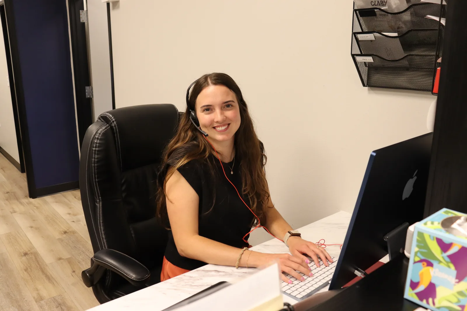ETLC learning specialist at her desk reviewing student accommodation plans on a computer