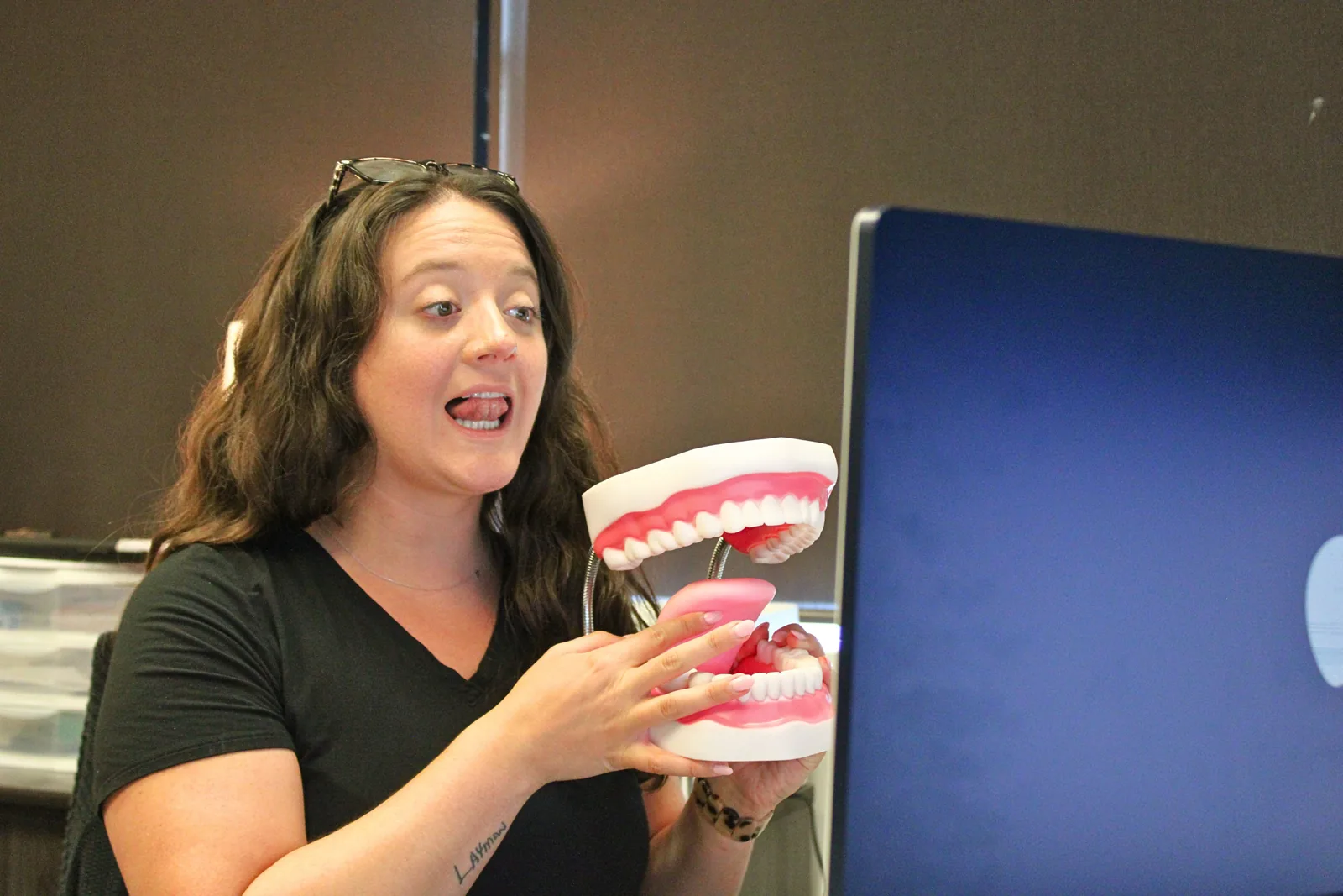 ETLC speech-language pathologist demonstrating mouth and tongue movements with an oral model