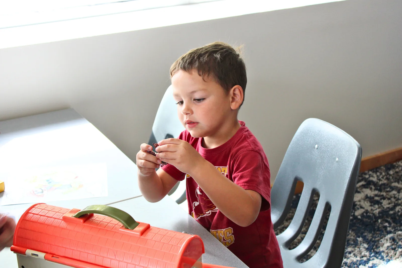Toddler exploring a hands-on toy during an early intervention session at ETLC