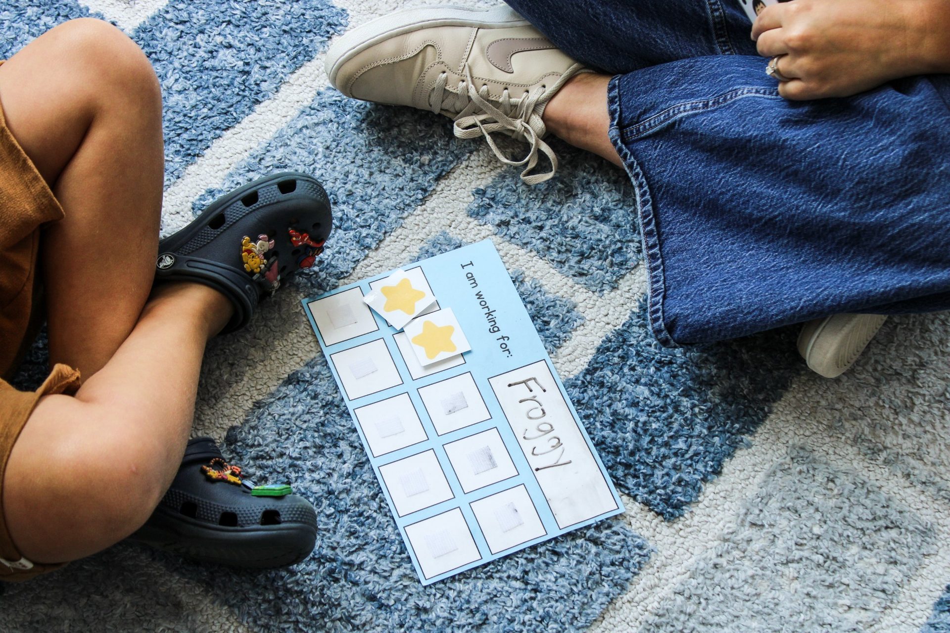 Speech-language pathologist working with a teenage boy on a drawing and organization activity