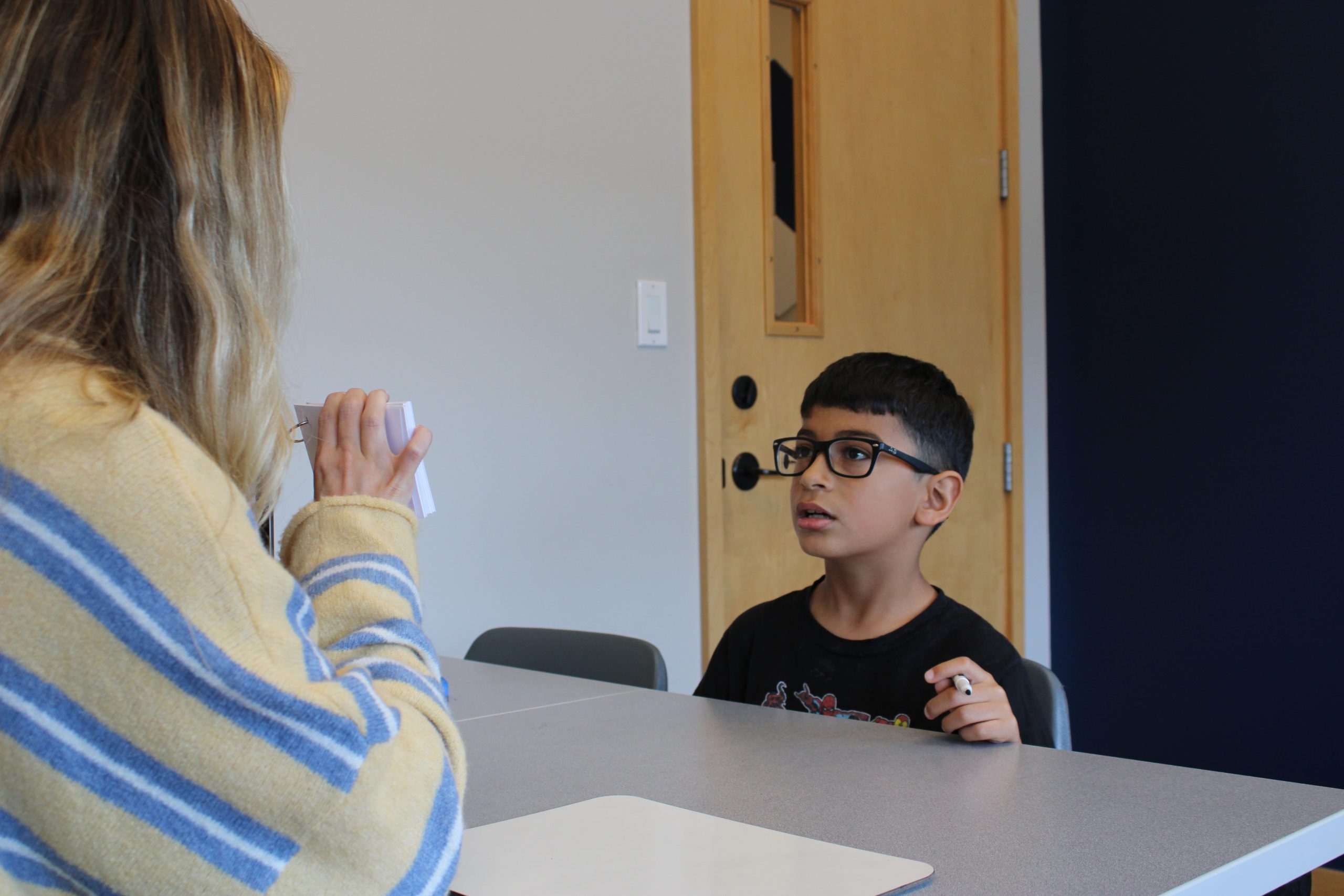 ETLC dyslexia therapy and reading support for children Speech-language pathologist supporting a child with dyslexia during a reading therapy session