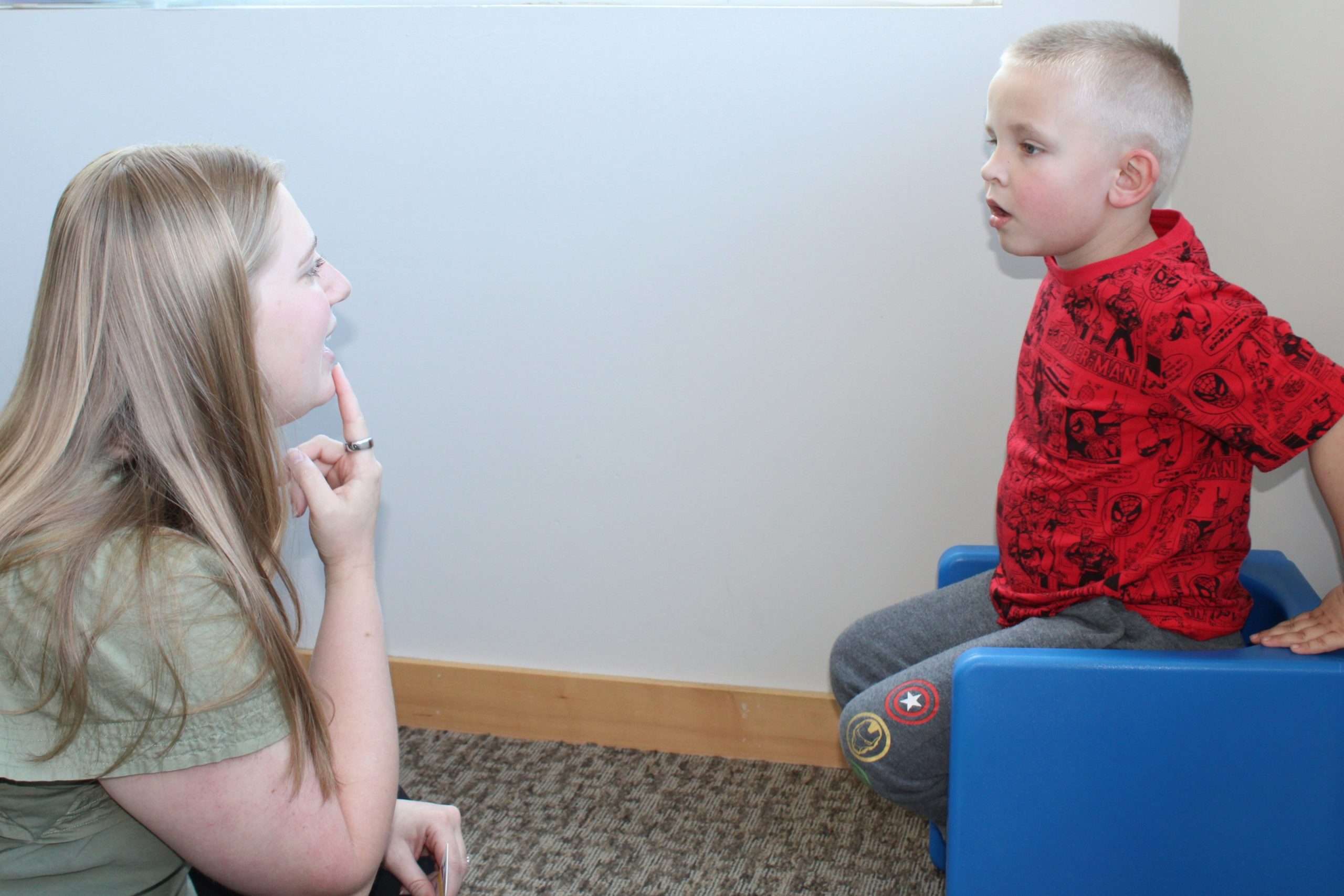 Parent working to improve toddler speech through play